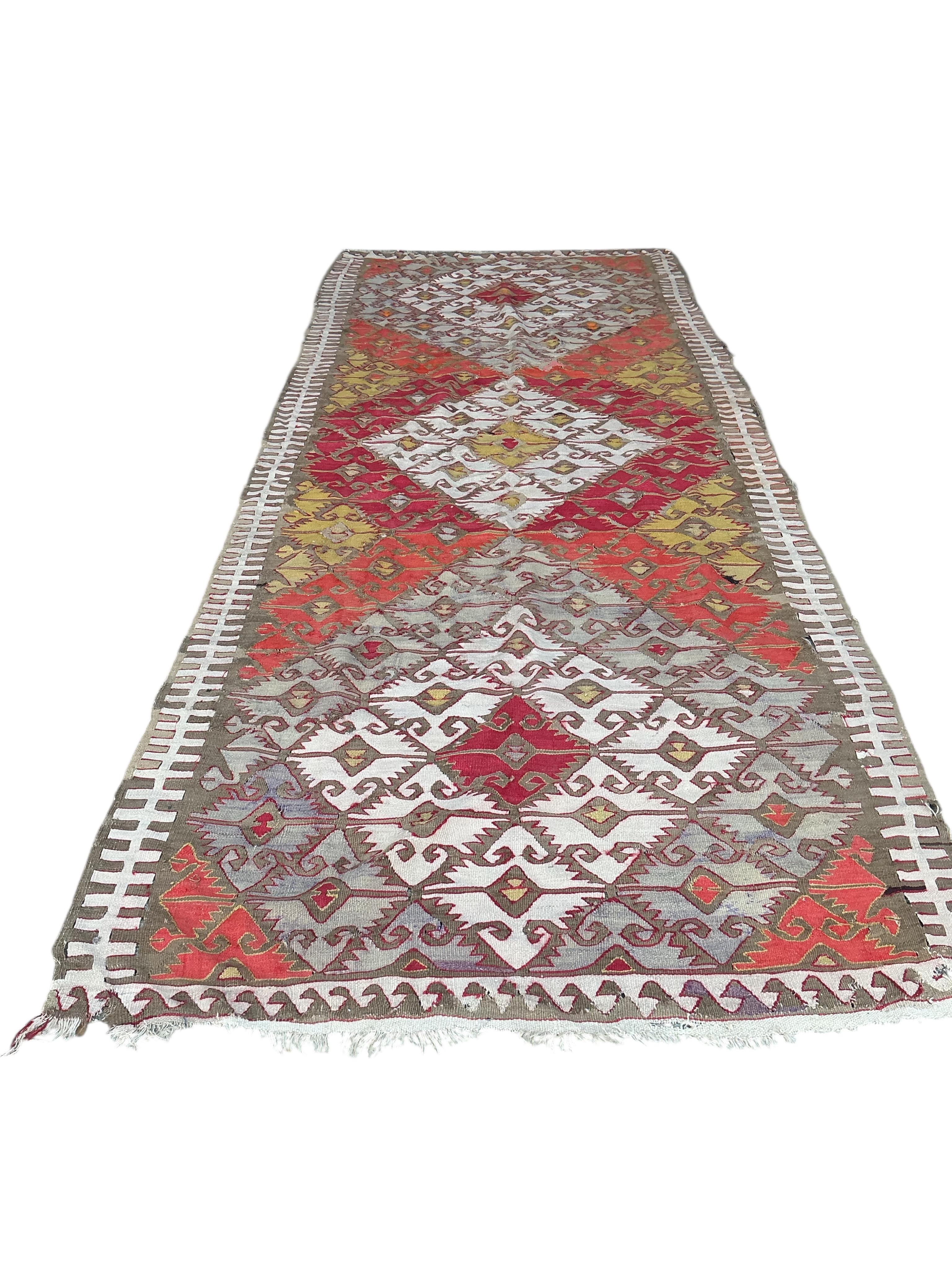 A Turkish multi-coloured Kilim flatweave rug, 330 x 130cm